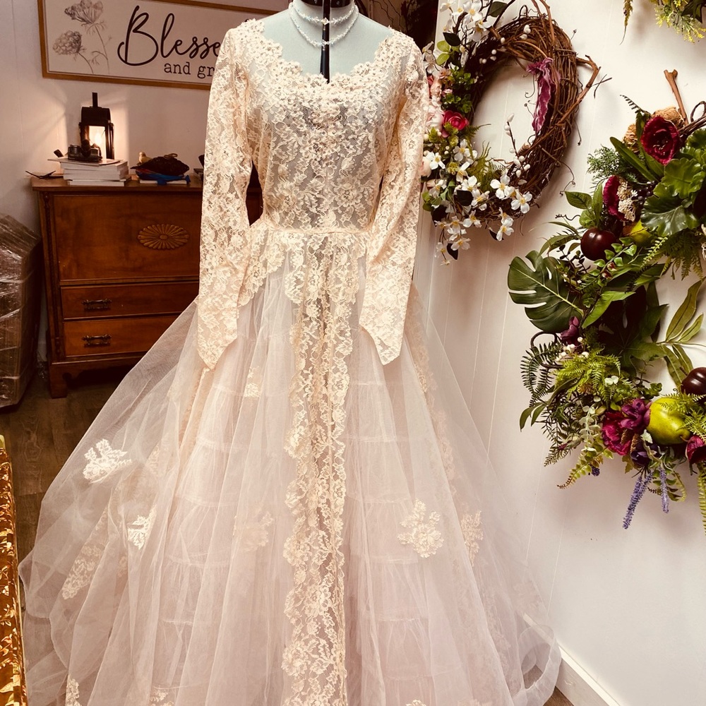 1940s or 1950s lace wedding dress peachy pink in color with amazing volume.